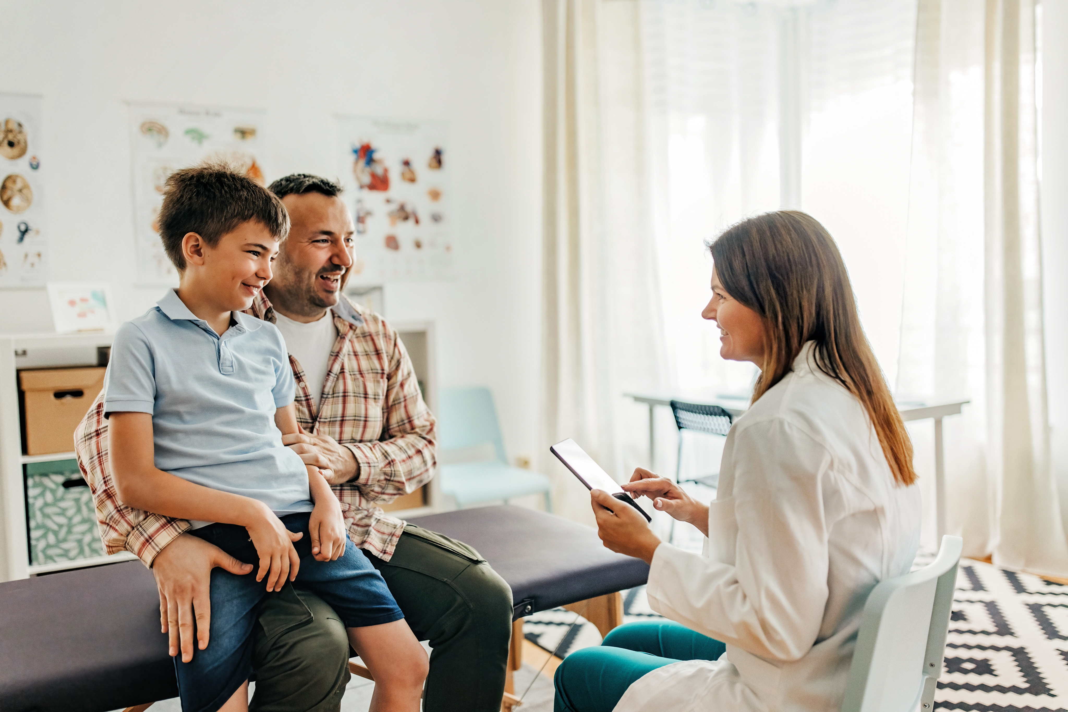 A man and his son visiting the pediatrician