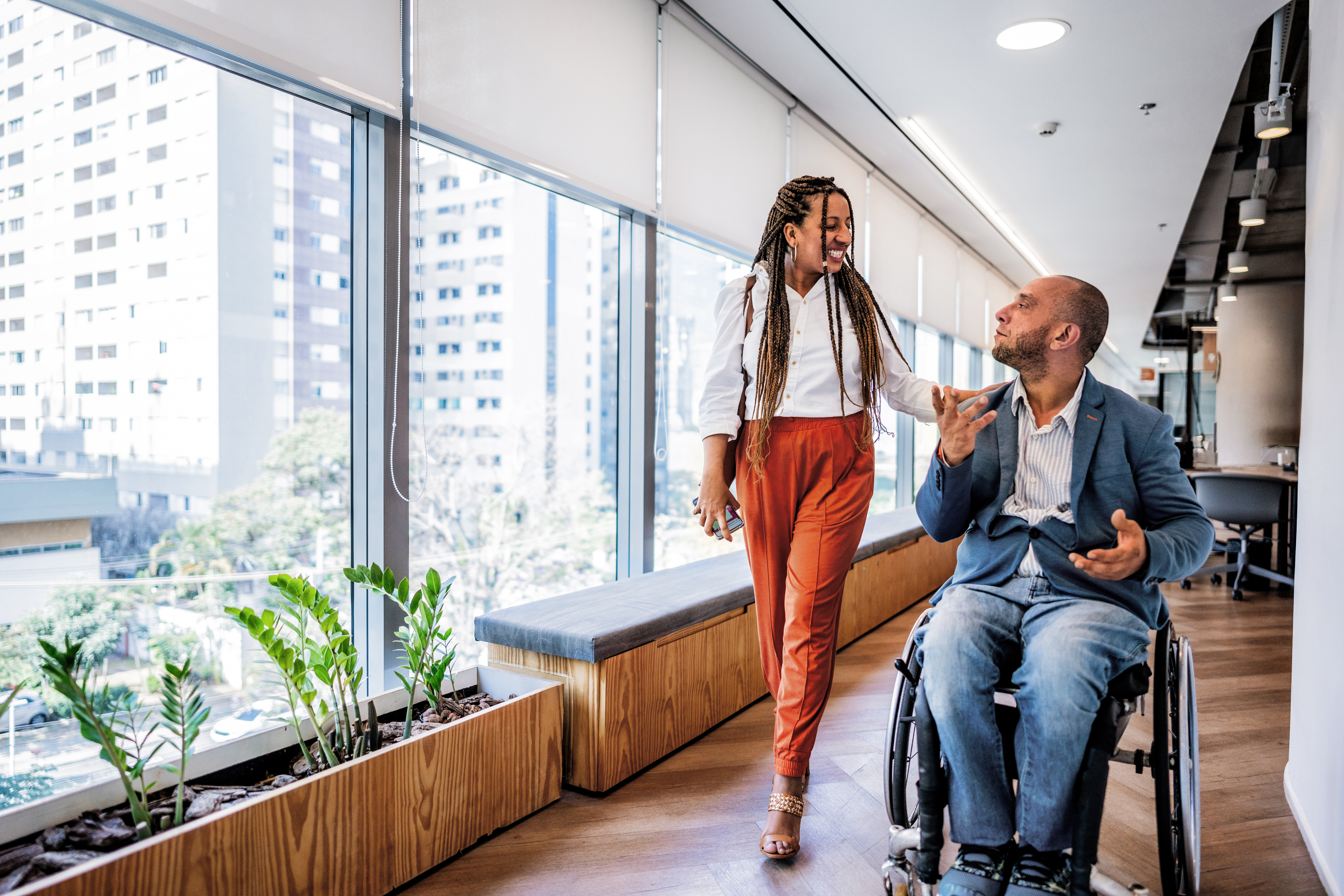 A woman and a man in a wheelchair chatting