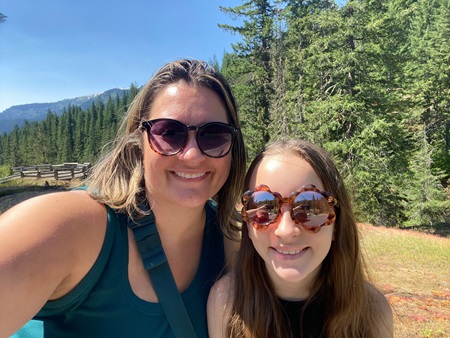 Two women wearing sunglasses outside
