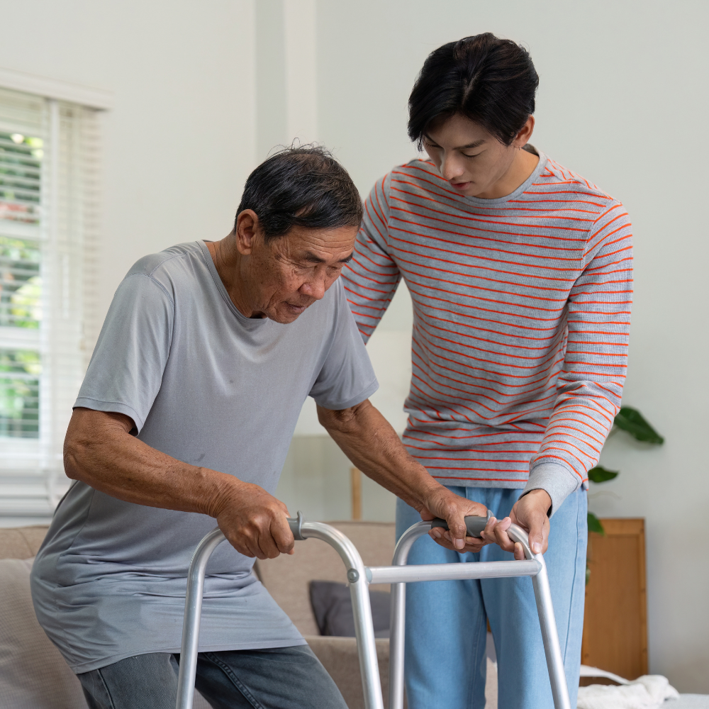 Caregiver helping adult stand up