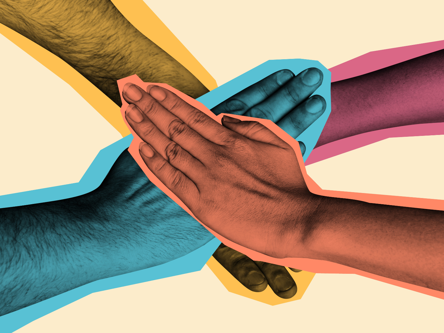 A close up of four hands overlapping to show cooperation.