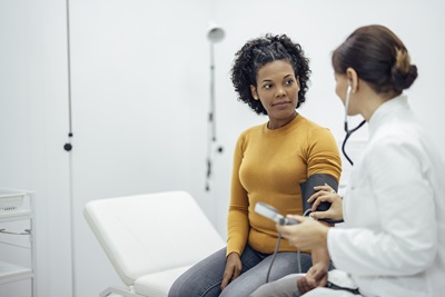 Doctor takes patients blood pressure