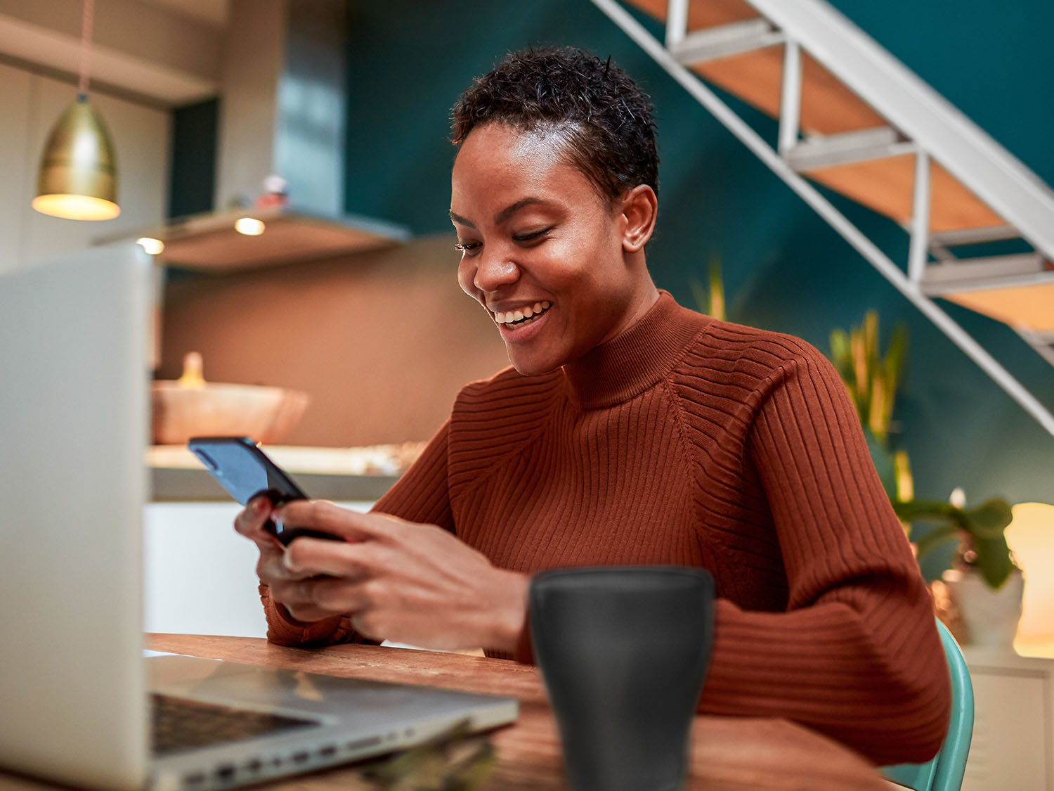 woman on a cellphone sitting at table
