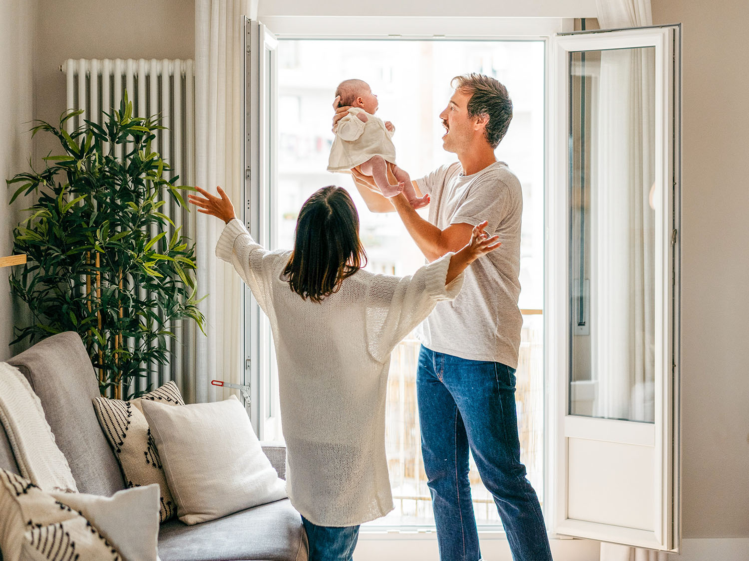 happy couple with the man holding a baby